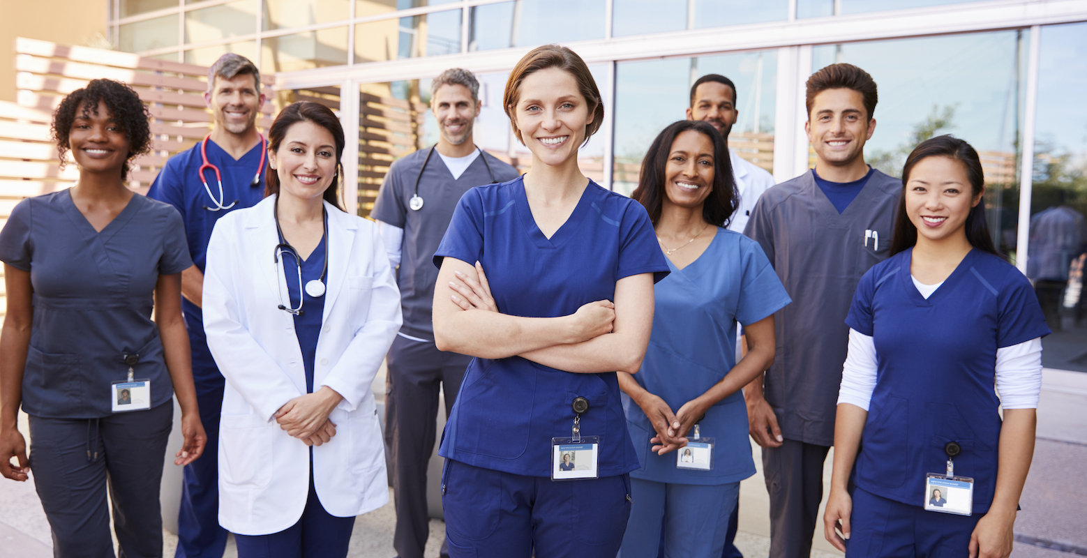 team-of-healthcare-workers-with-id-badges-outside.jpg