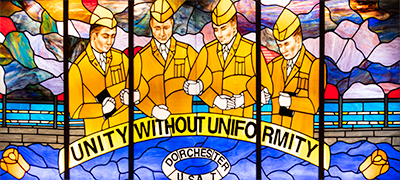 Stained glass portraits of the 4 chaplains. Photo by Briana Cummings.